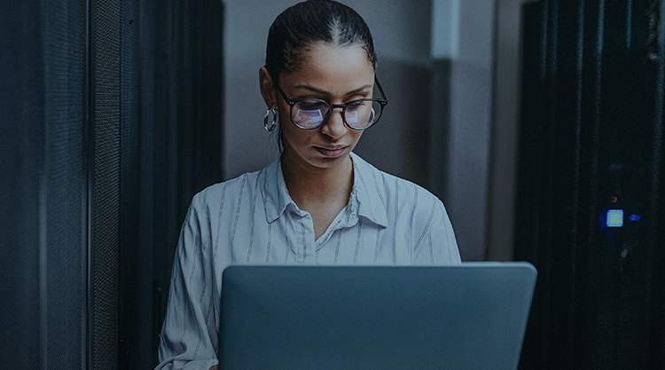 Adult woman typing on a laptop as she looks down