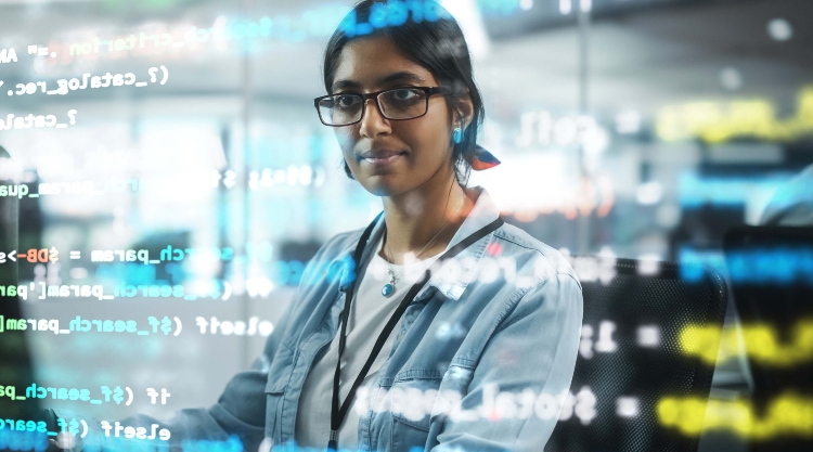 A woman analyzes data written on a transparent board