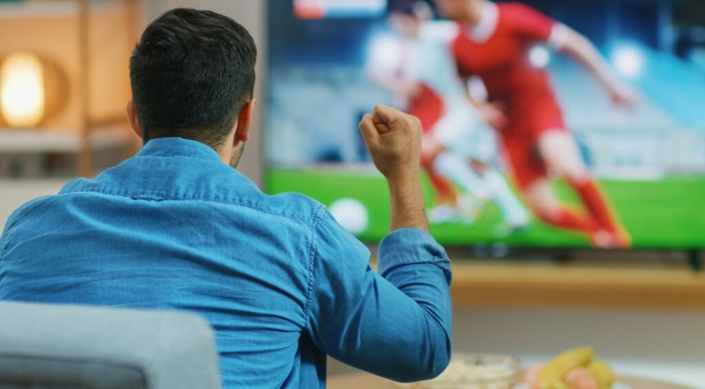 At Home Sports Fan Watches Important Soccer Match on TV