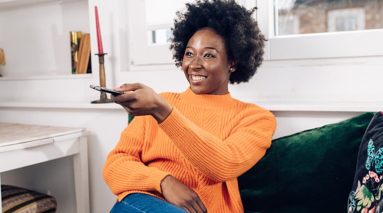 A young woman watches television