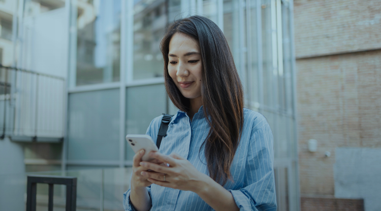 A young woman checks her mobile device