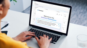 Featured image for the Buy Side platform blog. A person uses their laptop to access PubMatic Assistant.