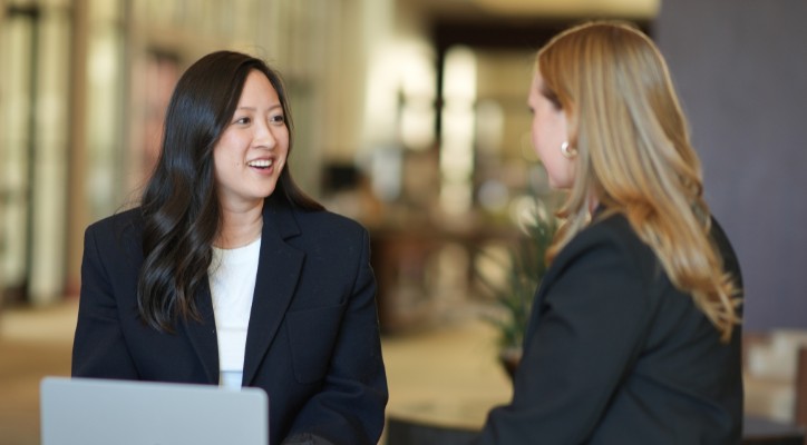 Two professional female colleagues are discussing their work-related matters